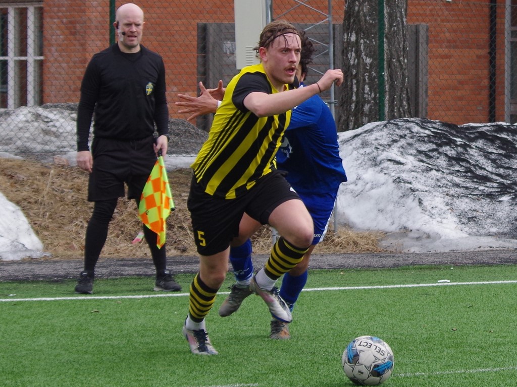 Petter Thelander rycker ifrån både en Sollefteåspelare och den assisterande domaren Roger Lundbäck. Foto: Pia Skogman, Lokalfotbollen.nu.